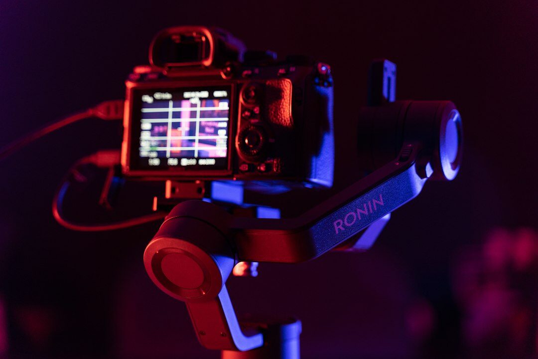 Camera and audio equipment on a wooden studio desk
