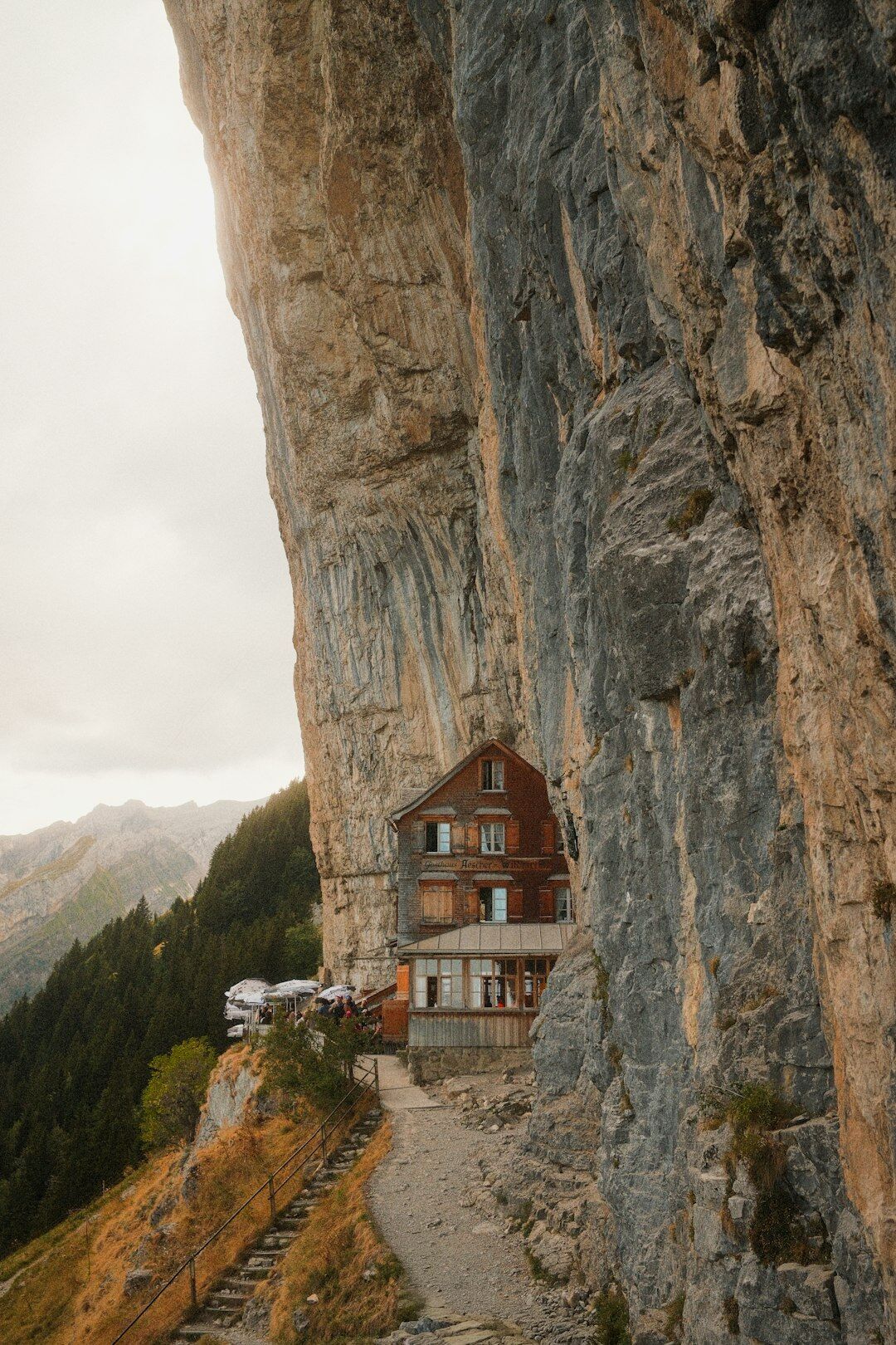 Woman filmmaker holding a video camera outdoors in the Swiss Alps